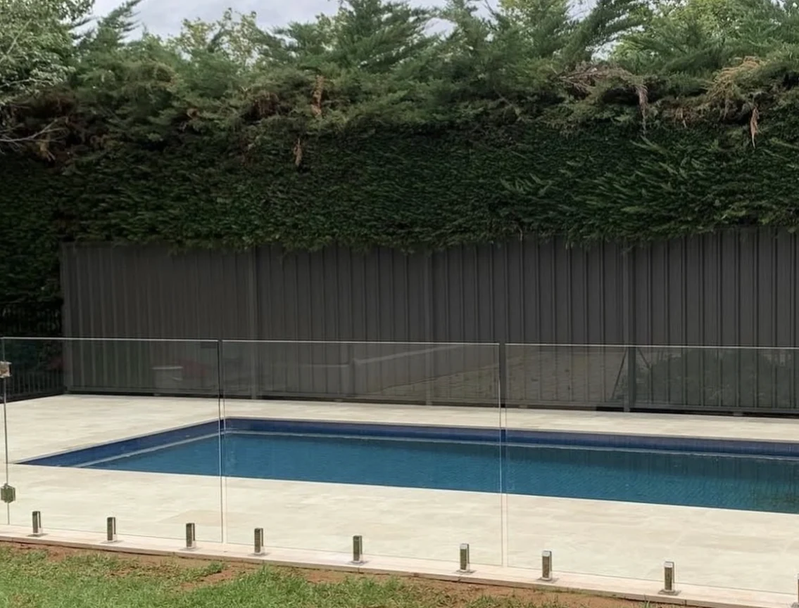 Finished pool, pale paving and planted garden edge