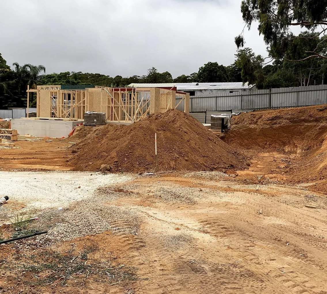 Excavated residential site with exposed levels and the building foundation visible