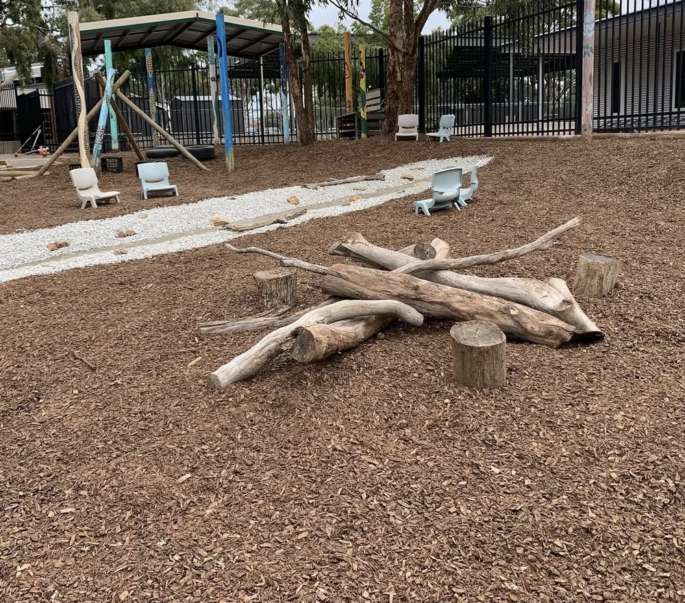 Nature play space with timber, mulch and stone
